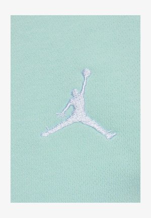 Mintgrüner Stoff mit einer strukturierten Oberfläche, auf der das weiße gestickte Jumpman-Logo prangt. Das Design hebt sportliche und lässige Kleidung hervor.