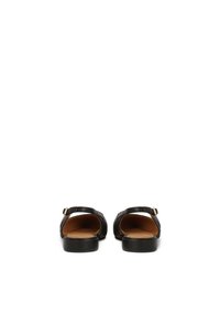 Black leather sandals with a flat sole, back heel strap, and an open toe design. Interior features a tan lining. Simple and minimalistic style.