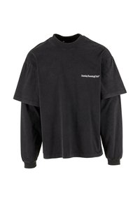 Czarna, oversize t-shirt z bawełny. Charakteryzuje się okrągłym dekoltem, krótkimi rękawami oraz napisem "Sunday Running Club" na lewej piersi.