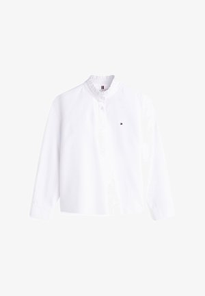 Camicia bianca a maniche lunghe con collo alto arricciato, patta con bottoni e piccolo logo Tommy Hilfiger sul petto a sinistra.