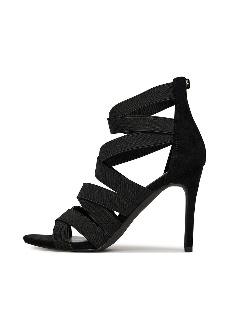 Mustad mustak kõrgpäka sandaal, millel on rihmadega disain, elastne pealmine kiht, nubuktekstuur, avatud varvapool ja stilletokonts. Tagant lukuga sulgemine.