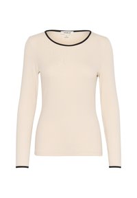Maglia a maniche lunghe color crema con scollatura rotonda bordata di nero e dettagli neri ai polsi. Realizzata in un morbido tessuto testurizzato.
