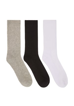 Calzini in misto cotone grigi, neri e bianchi. Ogni calzino presenta una texture a costine e una lunghezza classica a mezzo polpaccio.