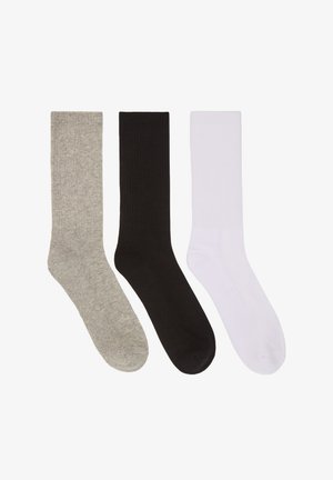 Calzini in misto cotone grigi, neri e bianchi. Ogni calzino presenta una texture a costine e una lunghezza classica a mezzo polpaccio.