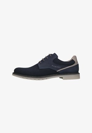 Navy blue lace-up shoe with textured mesh upper, contrasting suede accents, light gray sole, and subtle brand logo on side.