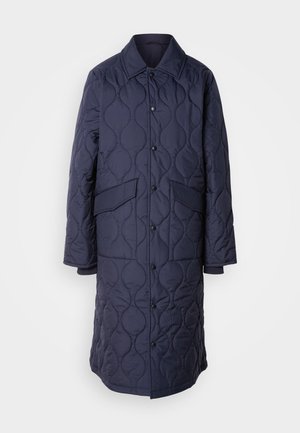 Navy quilted coat with a collar, front pockets, and snap-button closure. Features a distinct wavy pattern on the fabric texture.