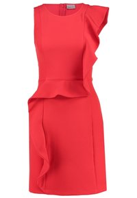 Robe rouge sans manches avec un corsage ajusté, un détail à volants sur un côté, et une jupe longueur genou. En tissu lisse avec une fermeture éclair dissimulée.