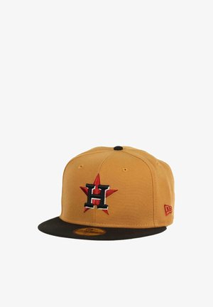 Yellow cap with a black visor. Features a raised embroidered "H" logo in black and red on a red star. Made of fabric with a smooth texture.