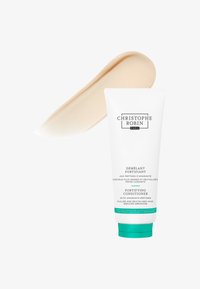 Après-shampooing fortifiant dans un tube blanc avec des accents verts. Produit crème beige montré à côté du tube. Texture lisse et brillante.