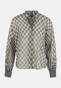 Transparent blus i krämfärg med geometriska svarta mönster, randiga ärmar och en volangkrage. Har långa ärmar med knappade manschetter.