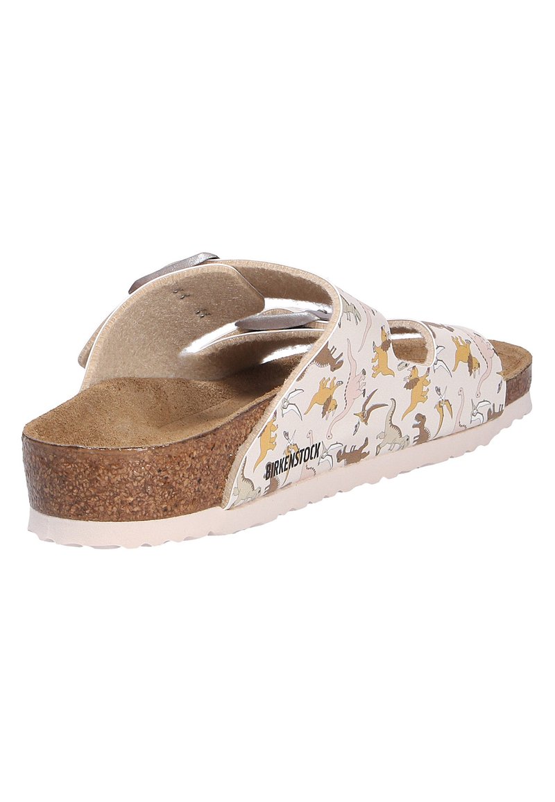 Sandale Birkenstock avec semelle en liège, semelle beige, deux sangles réglables ornées d'un motif de dinosaures multicolores et ludiques.