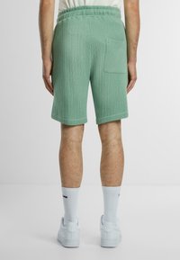 PROHIBITED Tracksuit bottoms - basilgreen