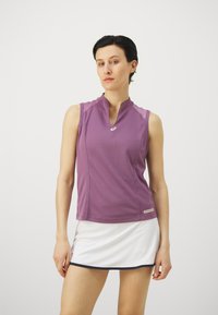 Purple sleeveless athletic top with a high collar and Asics logo, made of smooth fabric. Paired with a white athletic skirt, featuring navy trim.