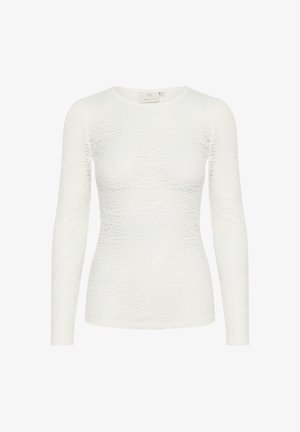 Fehér, hosszú ujjú felső, texturált anyagból, diszkrét hullám mintázattal. Kerek nyakkivágással és testhezálló fazonnal rendelkezik.