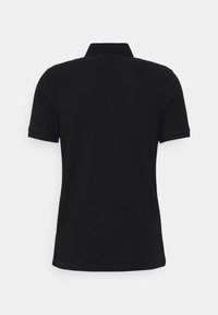 Polo noir à manches courtes vu de dos avec un col plat et sans logos ni motifs visibles.