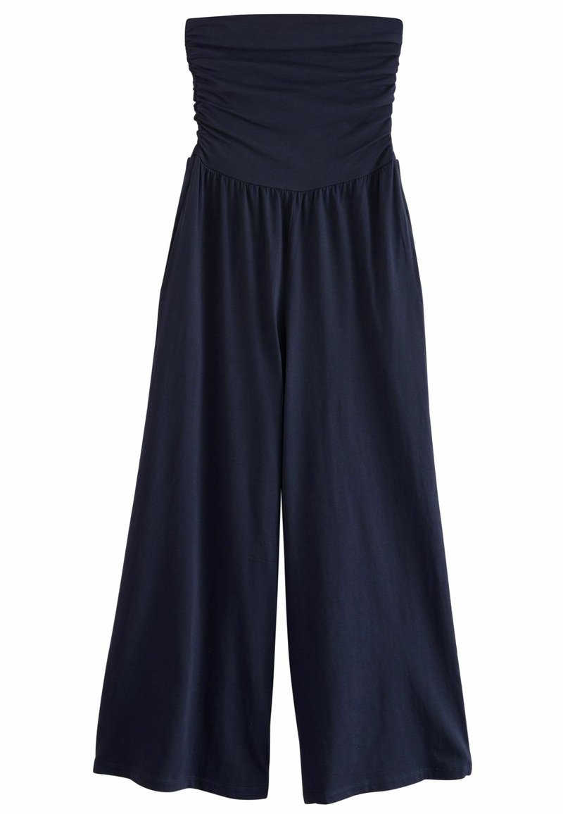 Mörkblå strapless jumpsuit med samlad överdel, vid ben-design, mjukt tyg och elastisk midja för komfort. Slät textur, avslappnad stil.