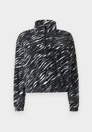 Pull-over en polaire noir et blanc avec un col montant et une fermeture éclair d'un quart, présentant un motif ondulé et une coupe décontractée et courte.