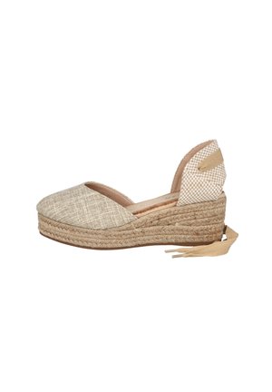 Sandalia espadrille beige con cuña, puntera cerrada, suela plataforma de yute trenzado, apoyo de tobillo de tela a cuadros y lazo beige en el talón.