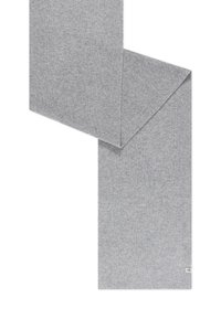 Light gray knitted wool scarf folded with small white fabric tag on one end against white background.