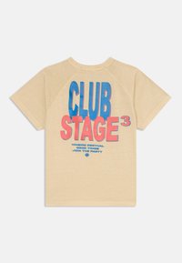 Béžové tričko s krátkym rukávom a okrúhlym výstrihom. Obsahuje farebný grafický text: "CLUB STAGE 3" v ružovej a modrej farbe s detailami festivalu nižšie.