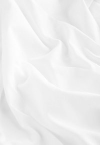 White fabric draped with soft, smooth texture, featuring gentle waves and folds. Light-filtering appearance with a matte finish.