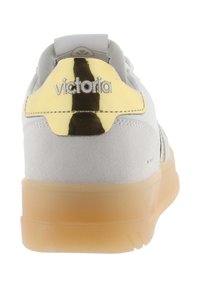 Sneaker con tomaia in suede grigia, accentuazione del tallone in oro metallico e suola in gomma trasparente. Presenta dettagli del logo cuciti e lacci tondi.