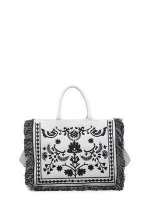 White tote bag with black floral embroidery and fringed edges, featuring a single handle for carrying.