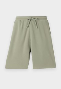 Ljusgröna shorts gjorda av ett texturerat tyg med elastisk midja och dragsnöre. Rakt snitt och knälång design.