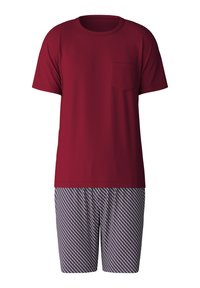 Rotes Kurzarm-T-Shirt mit einer Tasche, kombiniert mit gemusterten Shorts, die ein Diamantdesign in Blau, Weiß und Rot auf einem hellen Hintergrund haben.