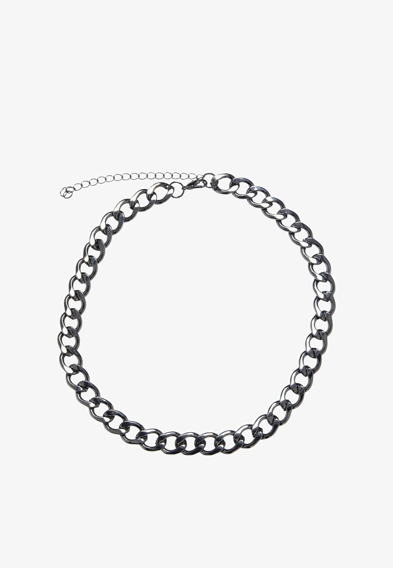 Stříbrný kovový řetízek s propletenými články, hladkým povrchem a krátkým nastavitelným zapínáním s prodloužením řetízku.