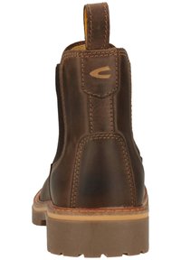 Braune Lederknöchelboots mit elastischen Seitenpanelen, Zuglasche und Gummisohle, die mit Nähakzenten und einer abgerundeten Spitze versehen sind.