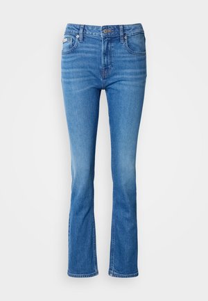 Zilās denim apakšbikses ar vidēju vidukļa augstumu, kas izceļas ar klasisko piecu kabatu dizainu un nedaudz izbalējušu tekstūru uz ceļgaliem.