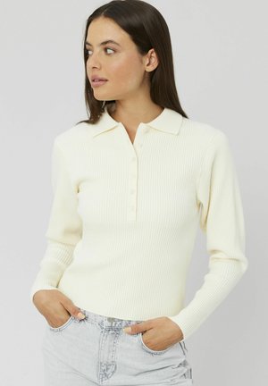 Polo à manches longues côtelé de couleur crème avec une patte de boutonnage et un col ; design ajusté avec une surface texturée.