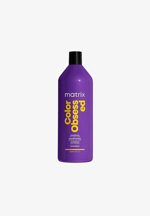 Paarse plastic fles van Matrix Color Obsessed conditioner; voorzien van vet gele tekst met productdetails en een zwarte flip-top dop. 33,8 fl oz.