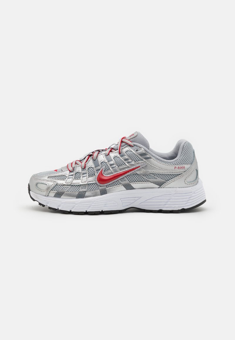 Silver running shoe with mesh upper, grey accents, red detailing, prominent swoosh, and cushioned white sole with black traction.
