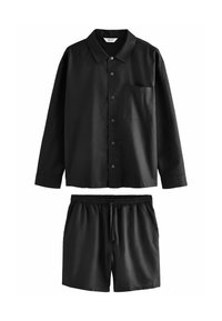 Black cotton short-sleeve shirt with a chest pocket and buttons, paired with matching elastic-waist shorts featuring side pockets.