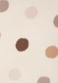 Textured fabric featuring a cream background with scattered, irregular polka dots in shades of brown, taupe, and muted mauve.