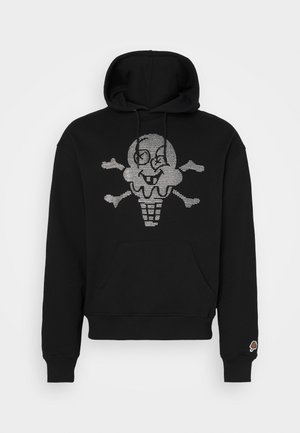 Black hoodie featuring a glittery ice cream skull graphic on the front, with a front pocket and ribbed cuffs. Small logo on the sleeve.