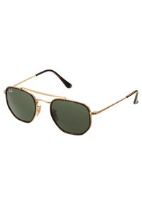 Gold metal sunglasses with dark green lenses, octagonal frame shape, and black accents on the tips of the arms. Made for optimal sun protection.