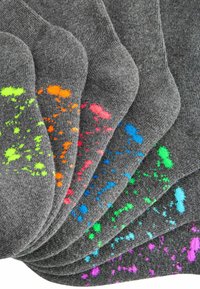 Chaussettes de crew grises avec des motifs éclaboussés vibrants en vert néon, orange, rose et bleu. Tissu texturé avec des bordures côtelées.