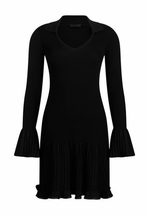 Vestido negro acanalado con mangas largas acampanadas, cuello en V y dobladillo con volantes. Fabricado en una tela suave y texturizada.