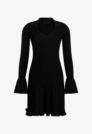 Sort ribbet kjole med lange udvidede ærmer, en V-hals og en rynket kant. Fremstillet af et blødt, struktureret stof.