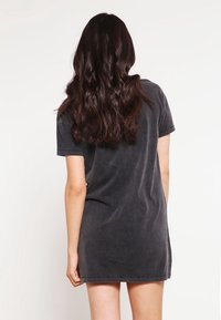 Robe t-shirt en coton gris charbon avec des manches courtes, coupe décontractée, texture lisse et ourlet à mi-genoux. Pas de motifs ni d'accents visibles.