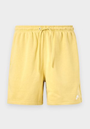 Yellow cotton shorts with an elastic waistband, adjustable drawstring, side pockets, and a white logo on the lower left leg.