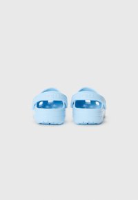 Light blue clogs with a closed heel, open sides, and textured footbed. Made of durable material with a traction sole. No distinct patterns.