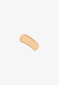 Beige cream makeup swatch with a smooth texture, featuring streaks for application, on a white background.