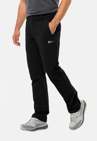 Black outdoor pants with a straight fit, made from stretch fabric. Features include side pockets and a small logo on the thigh.