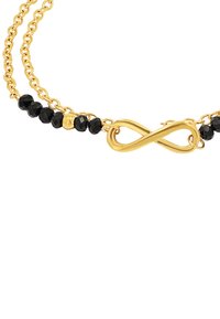 Bracciale in tonalità oro con un simbolo dell'infinito centrale, intervallato da perline nere sfaccettate e collegato da doppie catene.