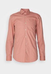 Lange mouwen, lichtroze knoopshirt. Heeft een kraag, knopen aan de voorkant en manchetten; gemaakt van een gladde stof met een reguliere pasvorm.