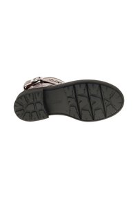 Black rubber sole with deep tread pattern, featuring a rounded toe. The upper section shows metallic accents and textured leather.